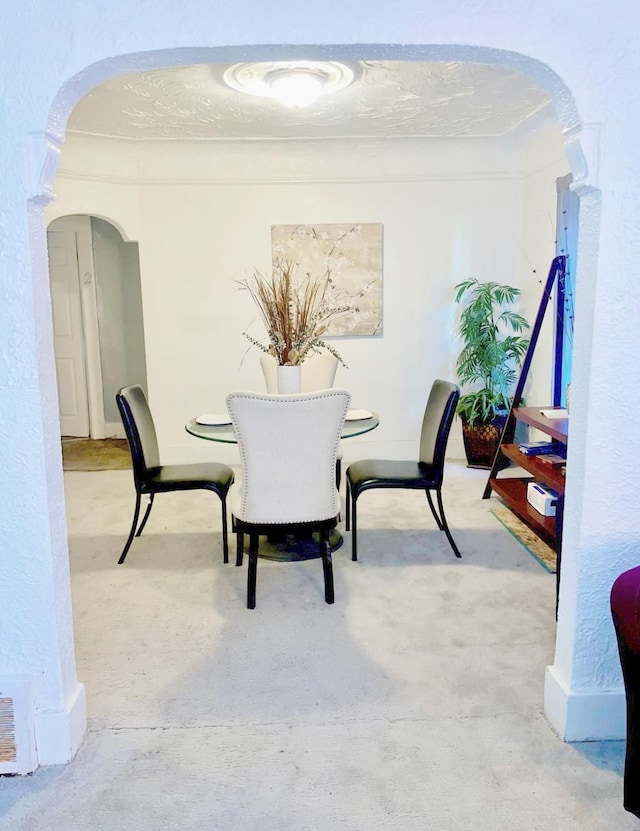 dining space featuring a textured ceiling and concrete floors