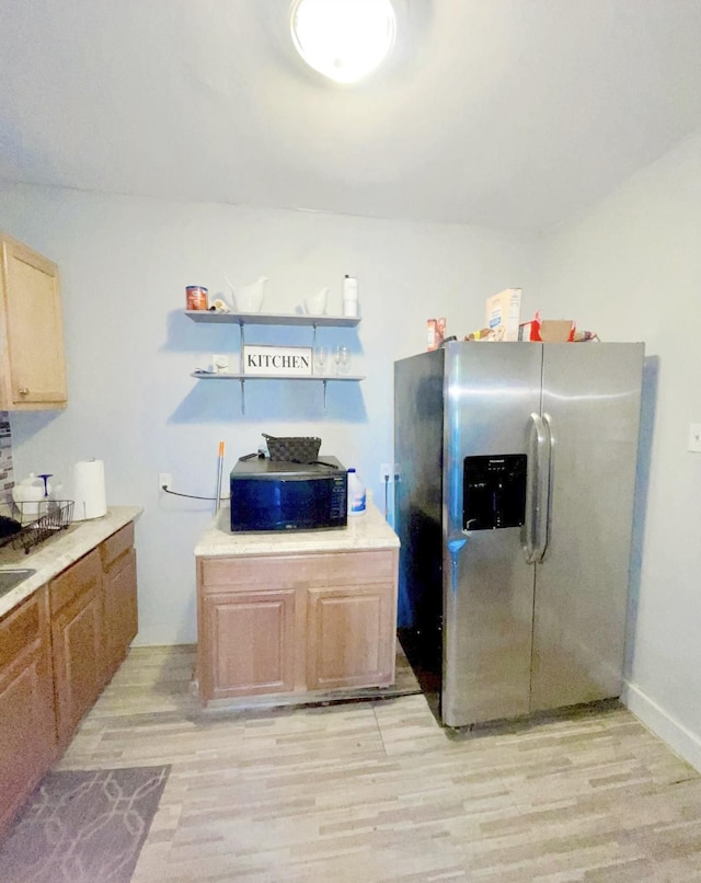 kitchen with light brown cabinetry, light hardwood / wood-style floors, and stainless steel refrigerator with ice dispenser