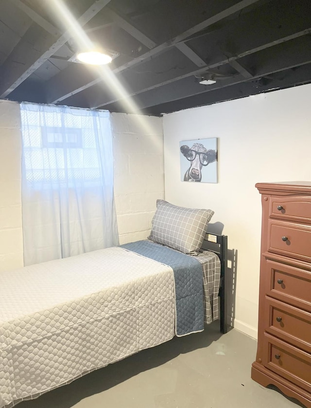 bedroom featuring concrete floors