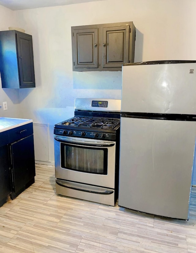 kitchen featuring light hardwood / wood-style floors and appliances with stainless steel finishes