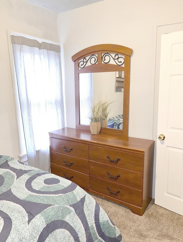 bedroom featuring light colored carpet