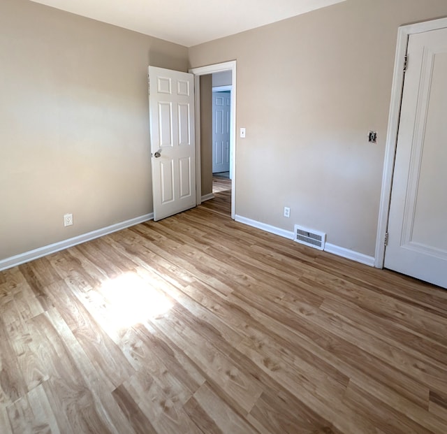 unfurnished bedroom with light wood-type flooring