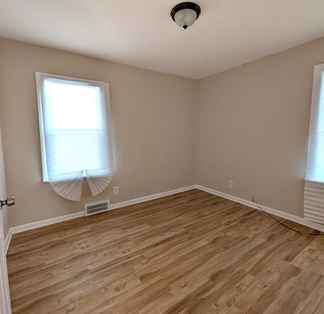 unfurnished room featuring light hardwood / wood-style flooring