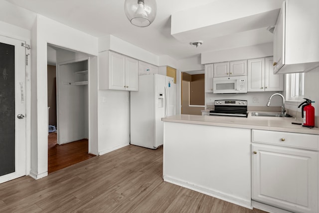 kitchen featuring white cabinets, white appliances, and sink