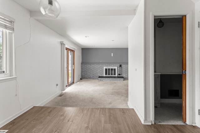 hallway featuring plenty of natural light and light colored carpet