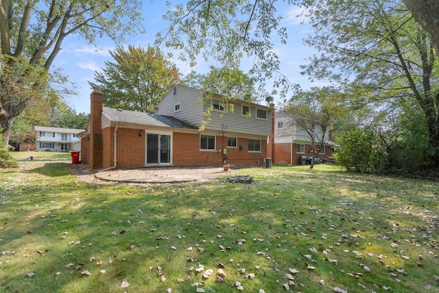 rear view of property featuring a yard and a patio