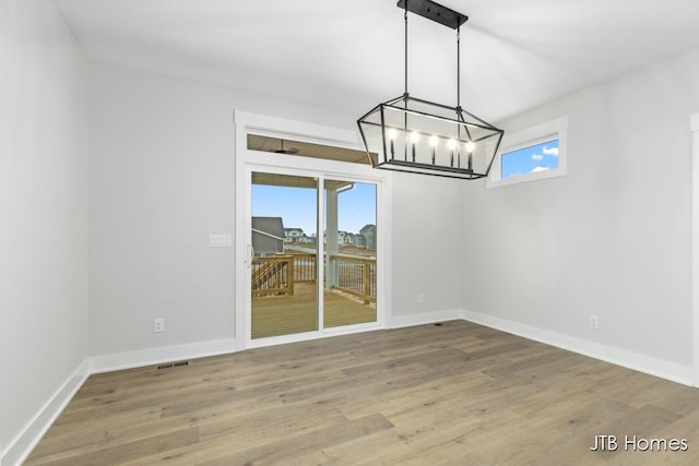 unfurnished dining area featuring hardwood / wood-style floors