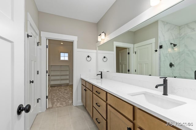 bathroom with tile patterned floors, vanity, and an enclosed shower