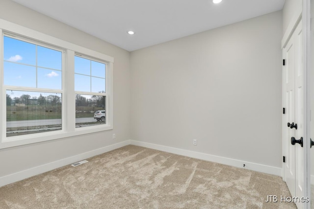 empty room featuring light colored carpet