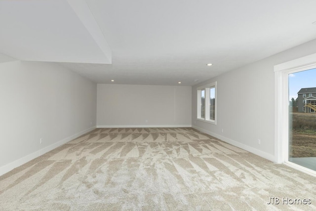 spare room featuring light carpet