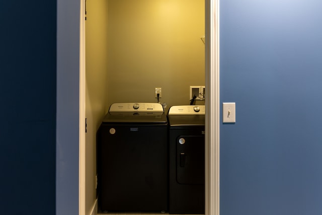 clothes washing area featuring washer and dryer