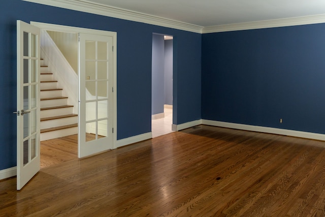 unfurnished room featuring french doors, wood-type flooring, and ornamental molding