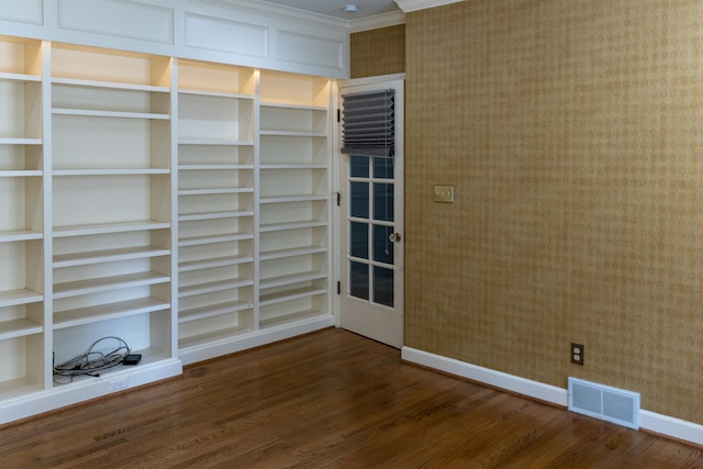 empty room featuring hardwood / wood-style floors and ornamental molding