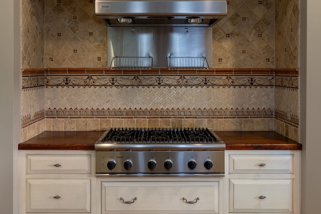 kitchen featuring wood counters, decorative backsplash, range hood, and stainless steel gas cooktop