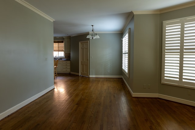 unfurnished room featuring sink, ornamental molding, dark hardwood / wood-style floors, and a notable chandelier