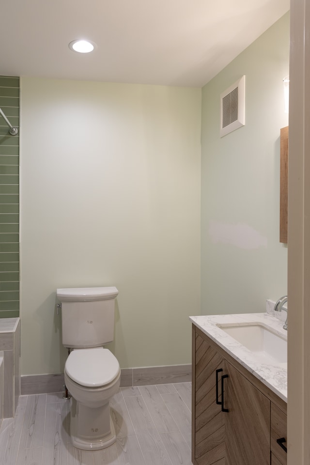 bathroom featuring hardwood / wood-style flooring, vanity, and toilet