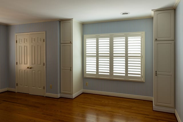 unfurnished bedroom featuring dark hardwood / wood-style flooring