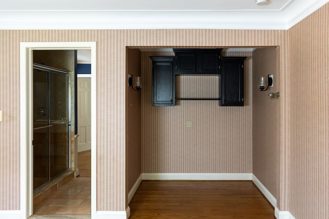 corridor featuring dark hardwood / wood-style floors and crown molding