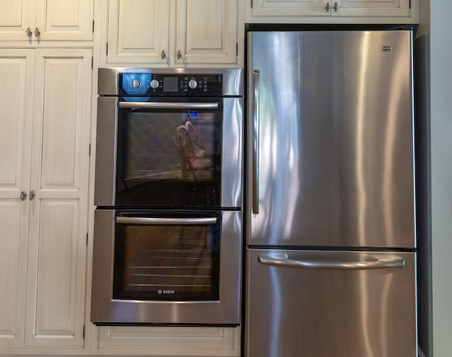 kitchen featuring white cabinets and appliances with stainless steel finishes