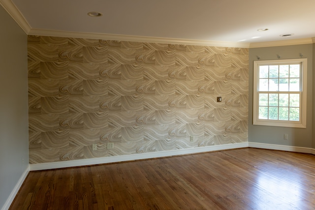 spare room with crown molding and hardwood / wood-style flooring