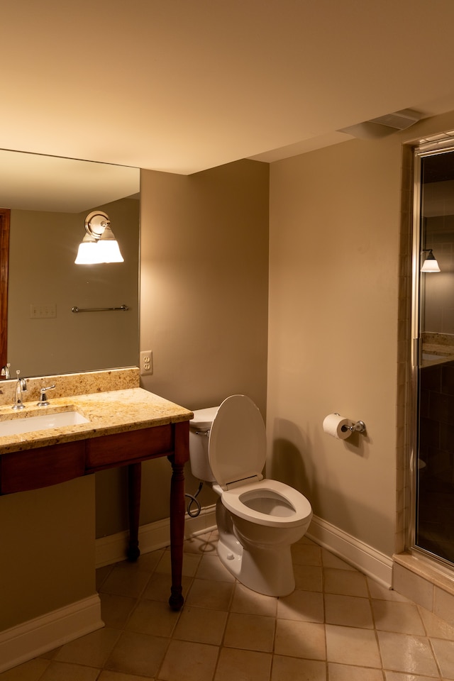 bathroom with tile patterned flooring, toilet, an enclosed shower, and sink