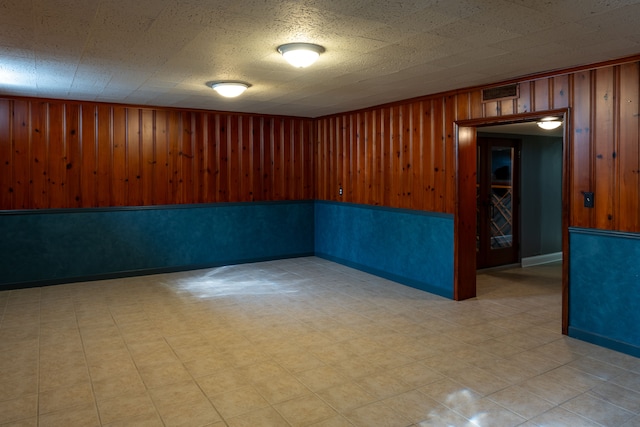 empty room featuring wooden walls