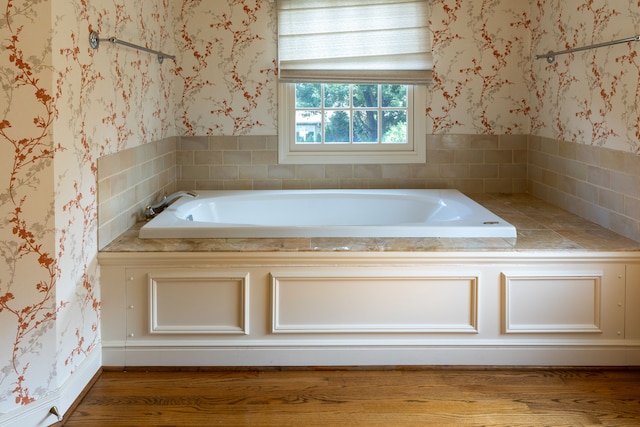 bathroom featuring a washtub and hardwood / wood-style floors