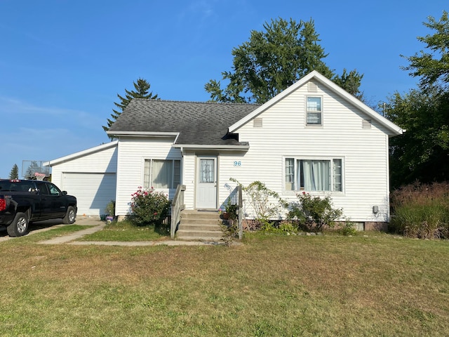 view of front of home with a garage and a front lawn