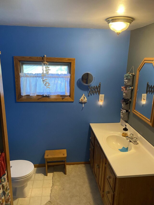 96 Harold St, Grant, MI 49327 - bathroom featuring vanity, toilet, and baseboards