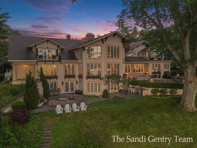 18635 N Fruitport Rd, Spring Lake, MI 49456 - back of property featuring french doors, a balcony, a patio area, an outdoor living space, and a chimney