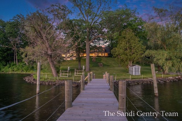 dock area featuring a yard and a water view