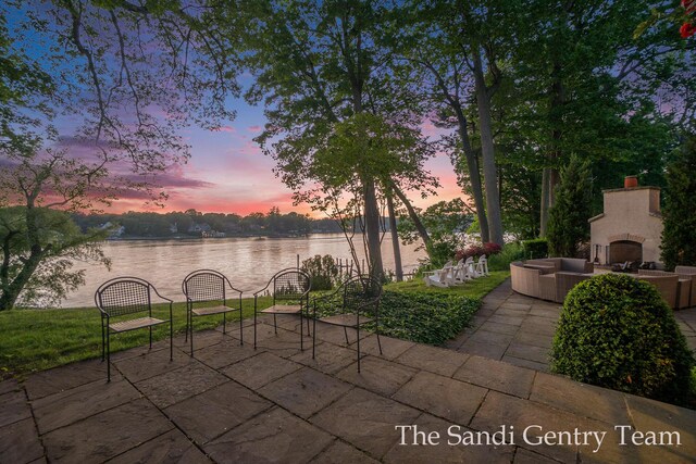 18635 N Fruitport Rd, Spring Lake, MI 49456 - view of patio featuring a water view and an outdoor living space with a fireplace