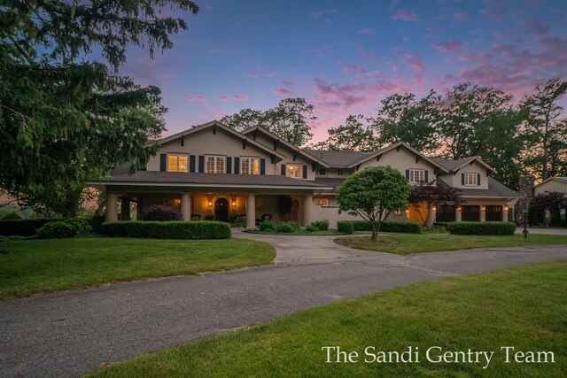 18635 N Fruitport Rd, Spring Lake, MI 49456 - traditional home with curved driveway, a front yard, and stucco siding