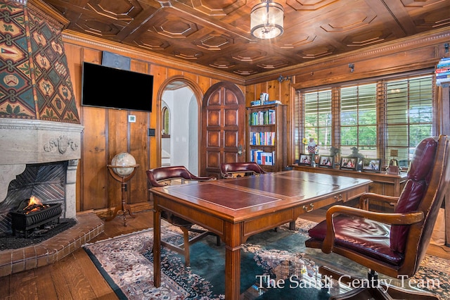 office space with wooden walls, crown molding, wood ceiling, and wood-type flooring