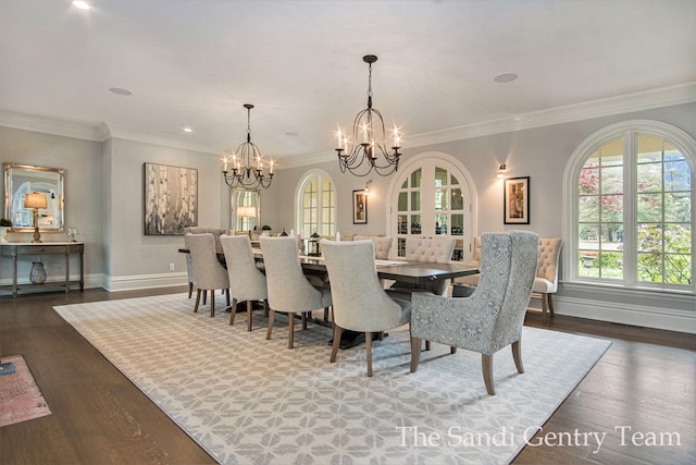 dining room featuring dark hardwood / wood-style floors, crown molding, and an inviting chandelier