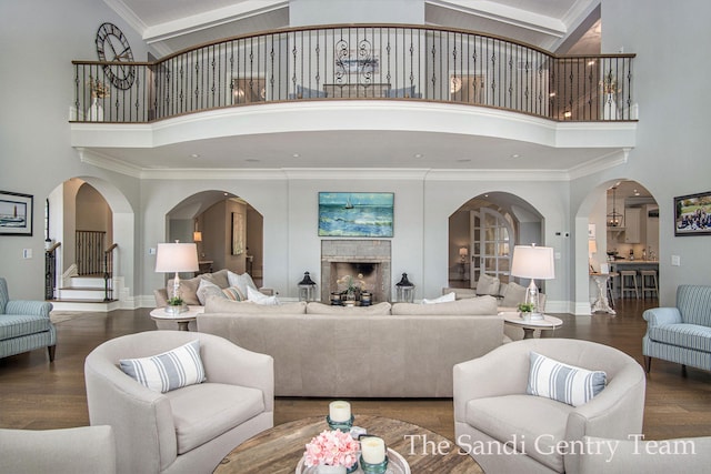 living room with a fireplace, high vaulted ceiling, and dark wood-type flooring