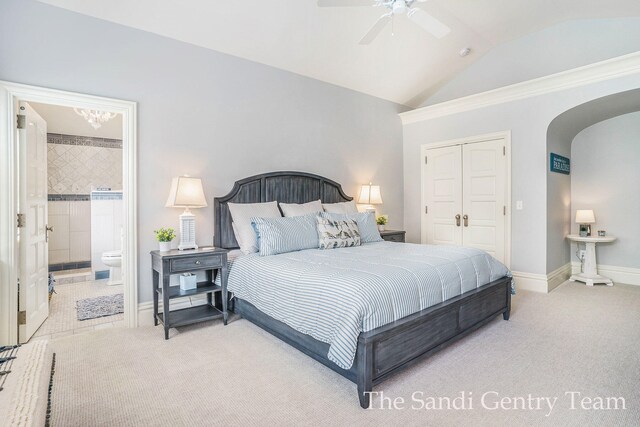 18635 N Fruitport Rd, Spring Lake, MI 49456 - carpeted bedroom featuring arched walkways, lofted ceiling, a closet, ensuite bath, and a ceiling fan