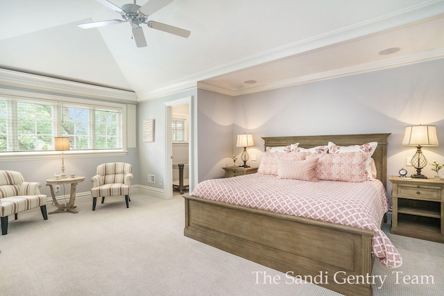 carpeted bedroom with ensuite bath, ceiling fan, crown molding, and vaulted ceiling