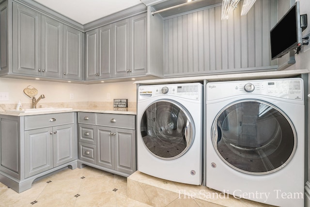 clothes washing area featuring cabinets, independent washer and dryer, light tile patterned flooring, and sink