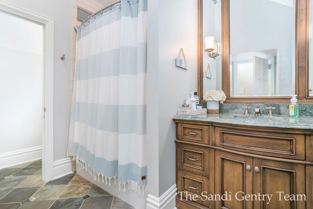 bathroom with a shower with shower curtain and vanity