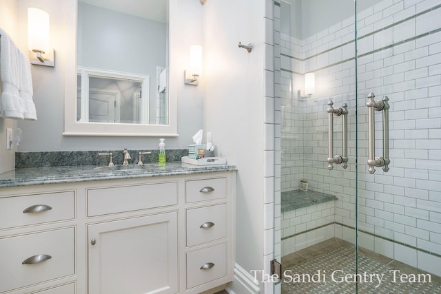 bathroom featuring vanity and a shower with door