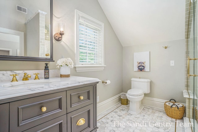 bathroom with tile patterned flooring, vanity, toilet, and lofted ceiling