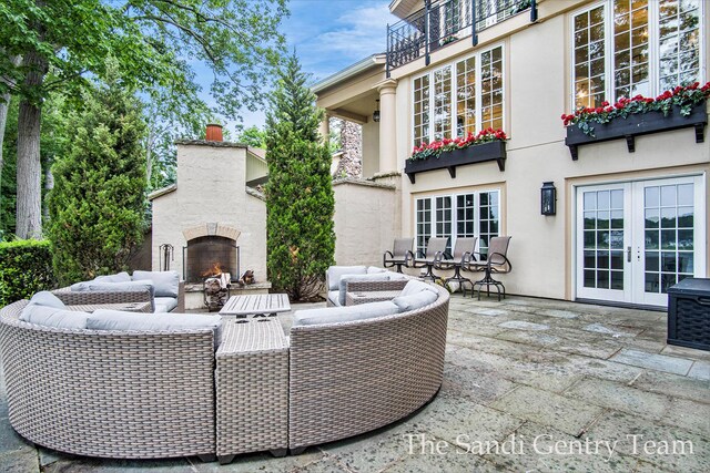 18635 N Fruitport Rd, Spring Lake, MI 49456 - view of patio / terrace with an outdoor living space with a fireplace and french doors
