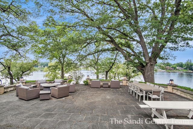 view of patio with an outdoor living space and a water view