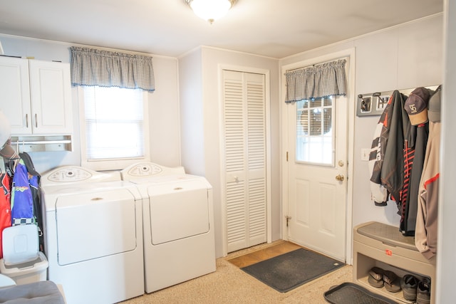 washroom with cabinets and washing machine and clothes dryer