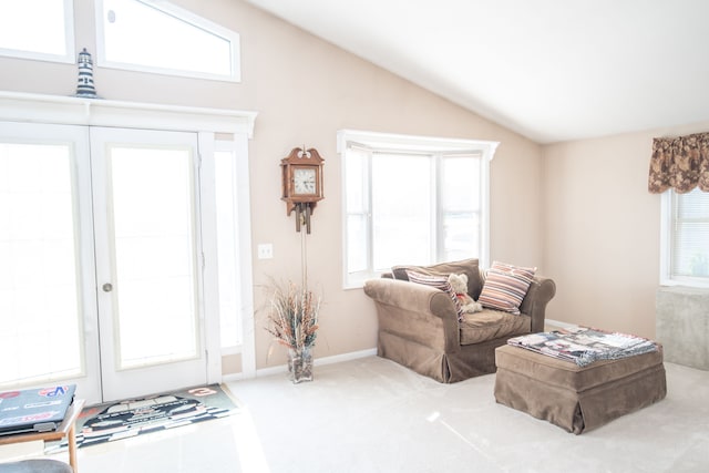 living room featuring carpet, vaulted ceiling, and a healthy amount of sunlight