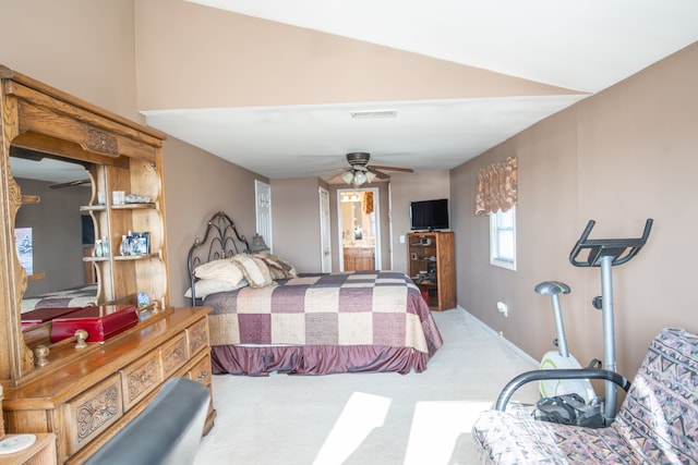 carpeted bedroom featuring ensuite bath, ceiling fan, and lofted ceiling