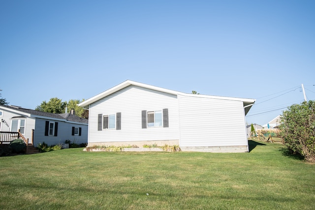 rear view of house featuring a yard