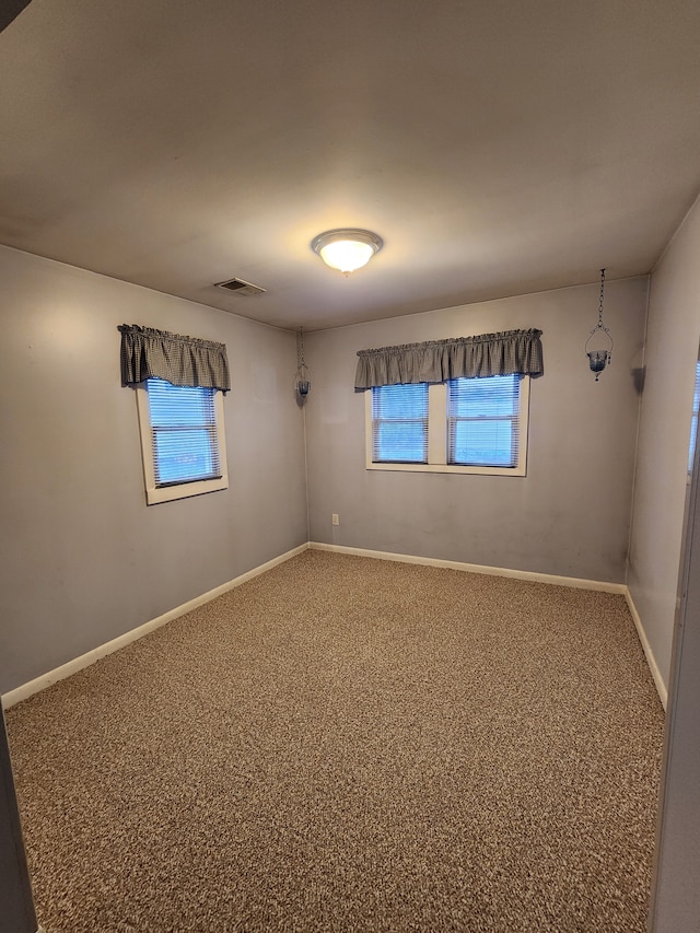 carpeted empty room featuring plenty of natural light