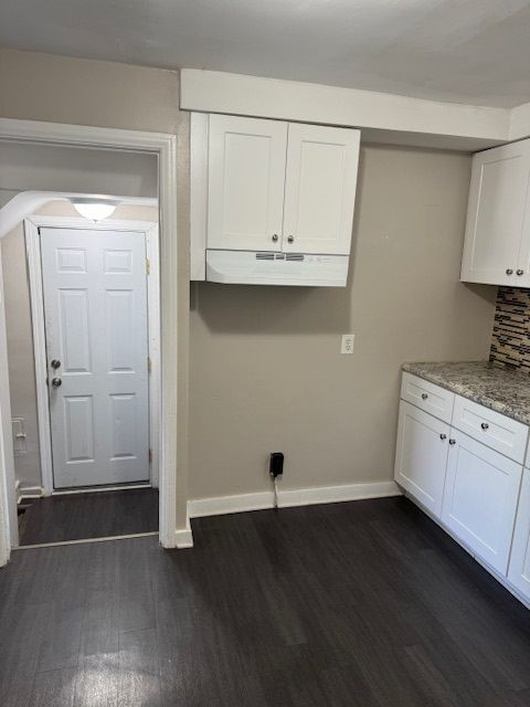 laundry room featuring dark wood-type flooring